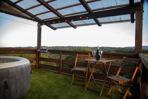 a patio with a table and chairs and a bath tub at Holiday home Sunce i Zora in Jalžabet