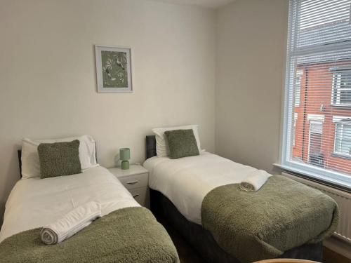 a bedroom with two beds and a window at *The Marshall*ContractorsStays*MonthyStays* in Leicester