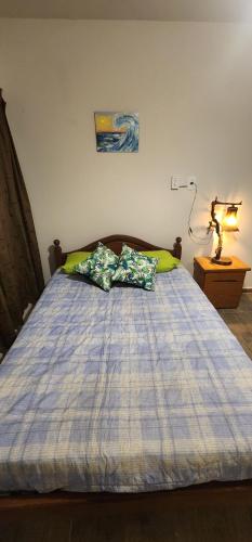 a bed with two pillows on it in a bedroom at Casa Malbec in San Martín