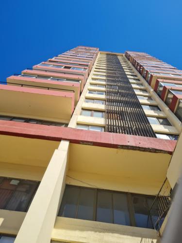 un edificio alto mirando hacia el cielo en Departamento Vina Centro (Portal Álamo), en Viña del Mar