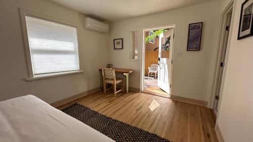 a room with a bed and a table and a window at The Parador in Santa Fe