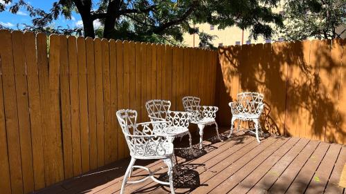 a group of chairs and tables on a wooden deck at The Parador in Santa Fe