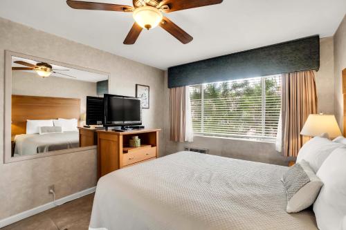 a bedroom with a bed and a flat screen tv at The Inn at Deep Canyon in Palm Desert