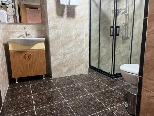 a bathroom with a shower and a sink and a toilet at E5 PARK OTEL in Esenyurt