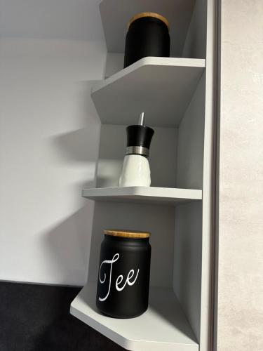 a cup of tea sitting on a shelf in a refrigerator at Neckarsulm ruhige Wohnung am Feldrand in Neckarsulm