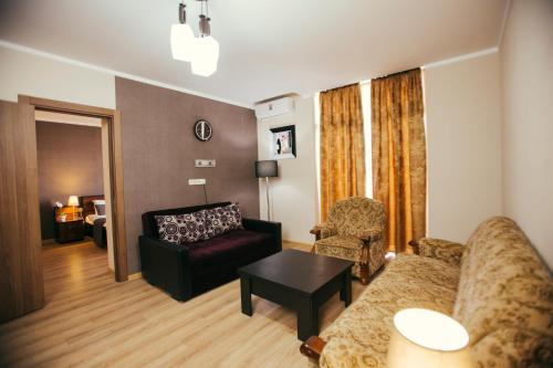 a living room with a couch and a table at Holidays in Panorama Batumi in Batumi