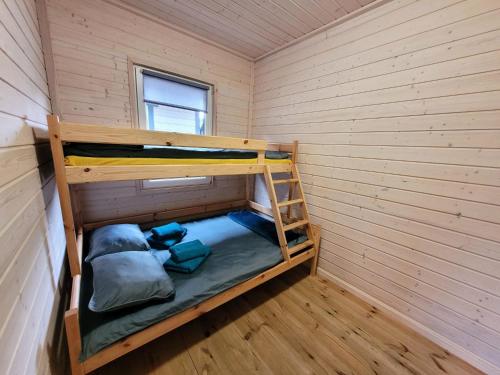 a room with two bunk beds in a wall at Pastelowe Borne in Borne Sulinowo