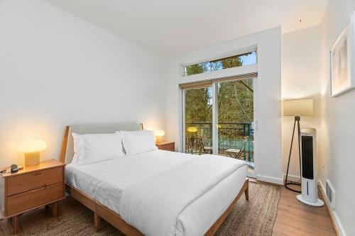 a bedroom with a large white bed and a window at Belltown's Flower Moon, near The Space Needle in Seattle