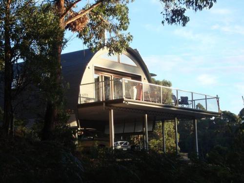 a house with a balcony on the side of it at Cocoon House in Newbury