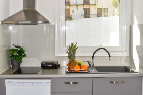 a kitchen with a sink and fruits on a counter at Anna and Jimmy's in Skiathos Town