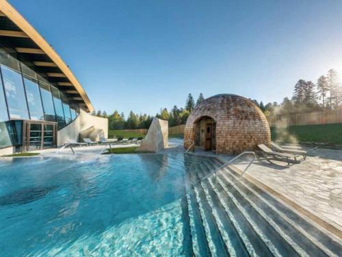 a large swimming pool in front of a building at L'Europ'appart : Gare, Center parcs, Parc St Croix in Sarrebourg