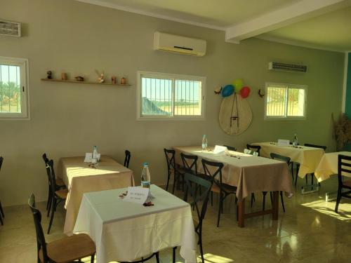 a dining room with tables and chairs and balloons at Garden12 Outdoor & More in Douz