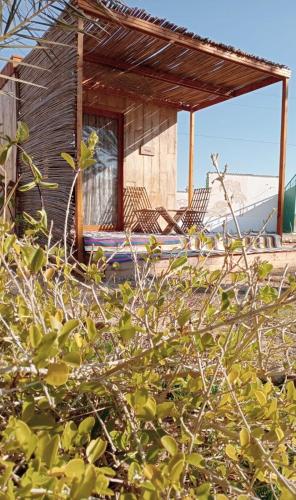 a house with two chairs sitting on a deck at Garden12 Outdoor & More in Douz