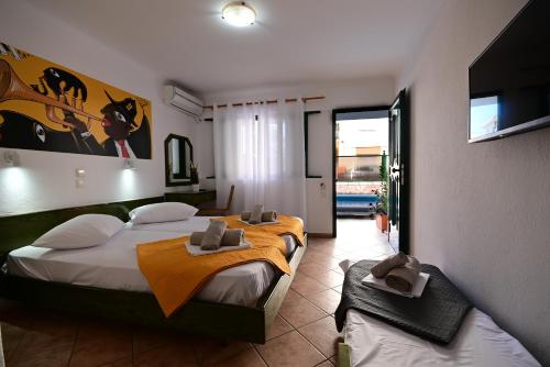 a bedroom with a large bed with towels on it at VILLA CARIATIS in Nea Kalikratia