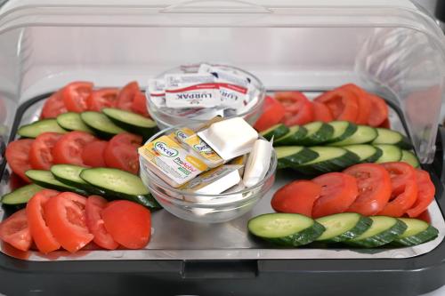 a plastic container filled with vegetables in a refrigerator at VILLA CARIATIS in Nea Kalikratia