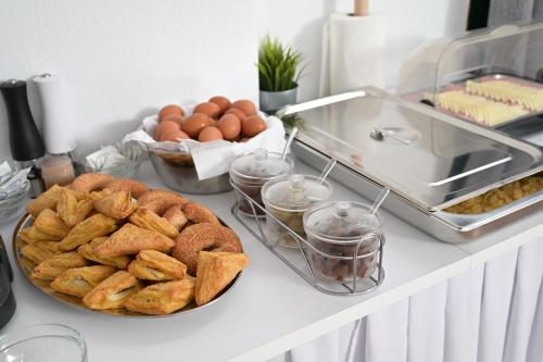 a counter top with a plate of bread and eggs at VILLA CARIATIS in Nea Kalikratia