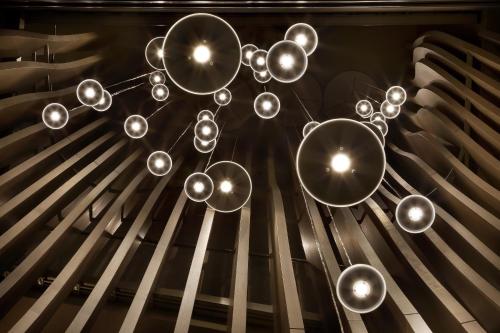 a chandelier hanging from the ceiling at ME Milan Il Duca in Milan