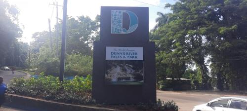 a sign in the middle of a street with a car at Ocean view with free beach access, pool and water park in Discovery Bay