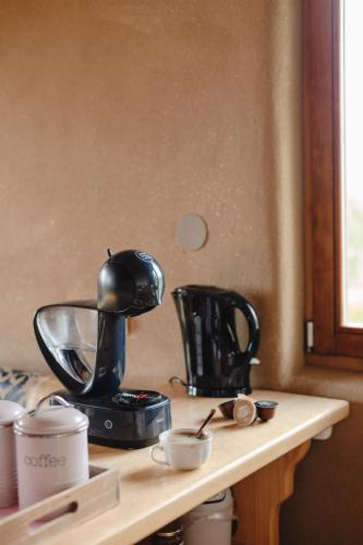 a kitchen counter with a coffee maker on a table at Holiday House Clavis in Dobrovnik