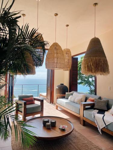 a living room with a couch and a table at SOL e MAR in Uvita