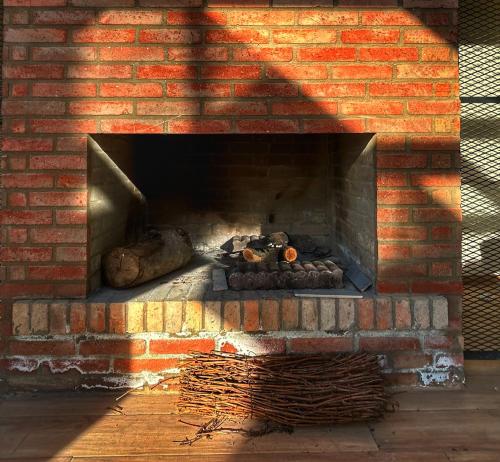 a brick oven with food and logs in it at Villa N40 in Kachretʼi