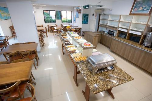 a long table with food on it in a restaurant at Hotel Vila Mar in Florianópolis