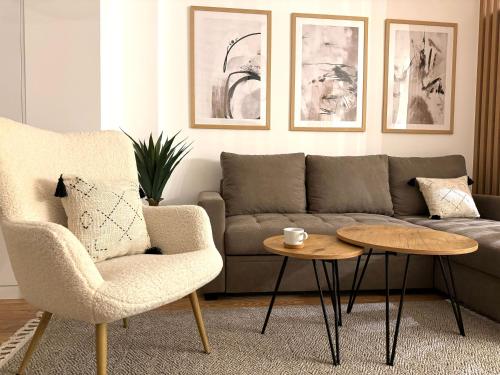 a living room with a couch and a coffee table at PineTree Jahorina in Jahorina