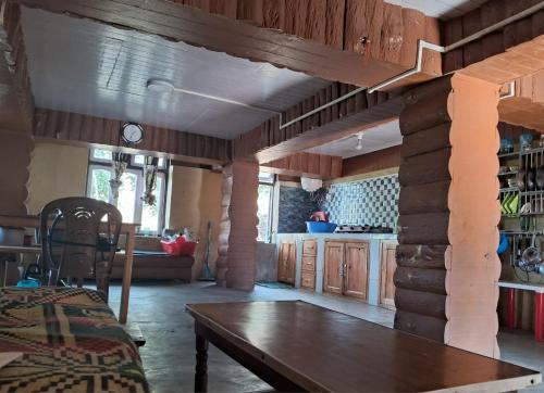 a kitchen with a wooden table in a room at Zen homestay in Ravangla