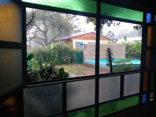 a view from a window of a backyard with a swimming pool at CASONA PINTORESCA en las sierras in San Roque
