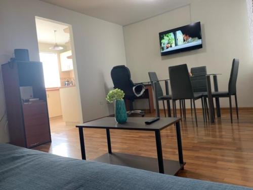 a room with a table with chairs and a tv at Costa Verde 2 Bedrooms Apartment Miraflores in Lima