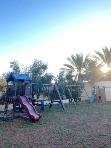 a playground with a slide and slidesktop at منتجع وِلف in Al Qā‘id