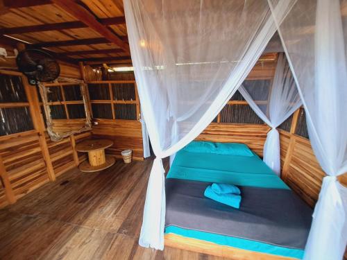 an inside view of a cabin with a bed at Coco Lodge, vista al mar in La Poza