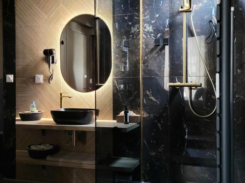 W łazience znajduje się umywalka i lustro. w obiekcie Tresors de Sens w mieście Sens