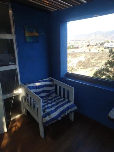 a blue room with a bench in front of a window at Cabaña marinera in Coquimbo