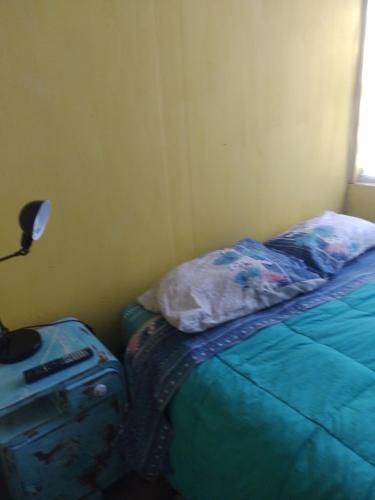 a bedroom with a bed and a luggage bag at Cabaña marinera in Coquimbo