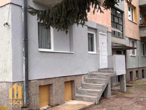 a building with stairs on the side of it at Apartman Ušće in Foča