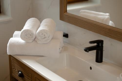 a bathroom sink with towels on top of it at Chalet Royal in Sinaia