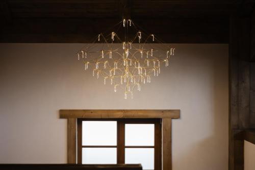 a chandelier hanging from a ceiling with a window at Chalet Royal in Sinaia