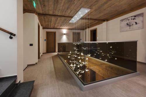 a long hallway with a glass exhibit in a building at Chalet Royal in Sinaia