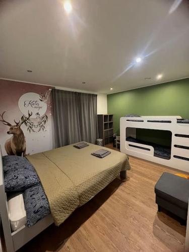 a bedroom with a bed and a tv in it at Forest Peace House in Straujupes