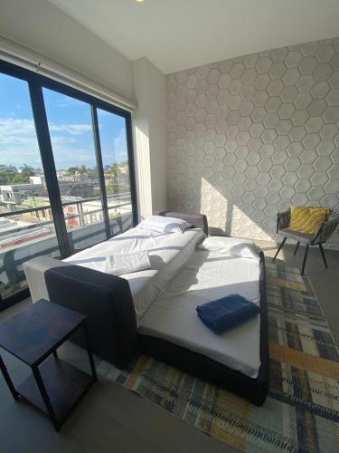 a bedroom with a large bed and a large window at Condo in El Centro Near Malecon! in Mazatlán