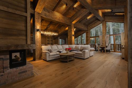 a living room with white couches and a fireplace at Chalet Royal in Sinaia