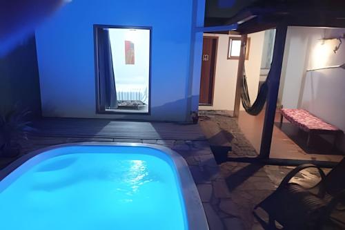 a swimming pool in a house with blue lighting at Espaço Luz in Paraty