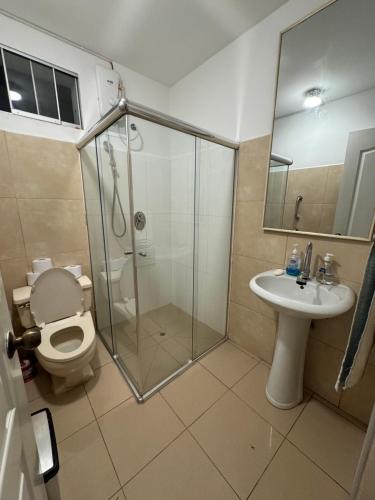 a bathroom with a shower and a toilet and a sink at Apartamento Florentino 101 in Lima