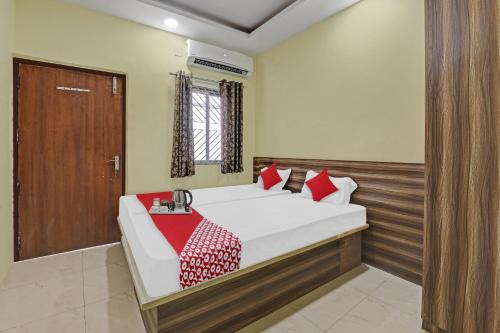 a bedroom with a bed and a wooden door at OYO Flagship Hotel Maheshwari Residency in Rānchī