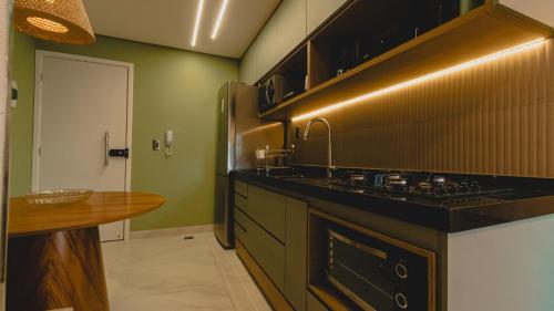 a kitchen with a sink and a counter top at Flat centro Porto de galinhas in Porto De Galinhas