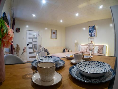 a dining room with a table with plates and glasses at Apartament Classic Comfort Aleja NMP 8 - Free parking in Częstochowa