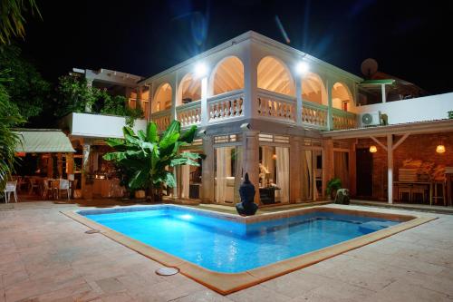 a large house with a swimming pool at night at Villa Kapresse du 978 - Guest house in Saint Martin