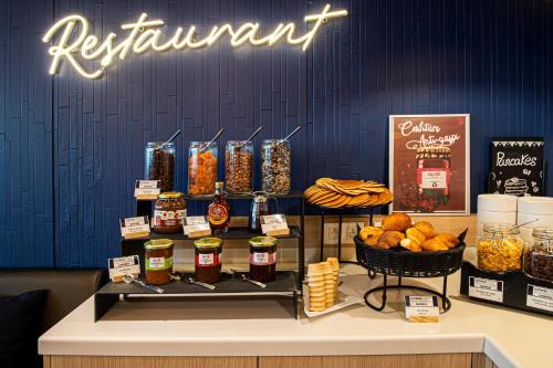 a display of food on a table in a store at Holiday Inn Express Paris-Canal De La Villette by IHG in Paris