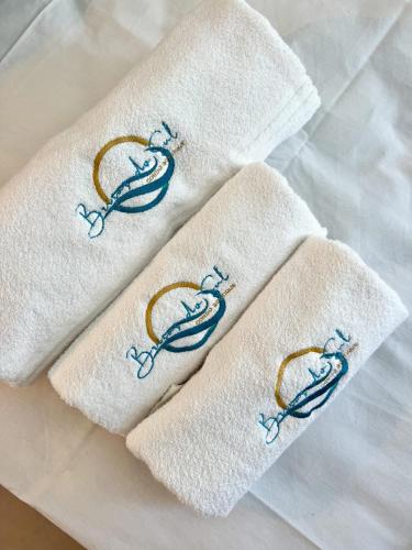 two white towels with a pair ofhooks on them at Brisas do Sul Condo Boutique in Pipa